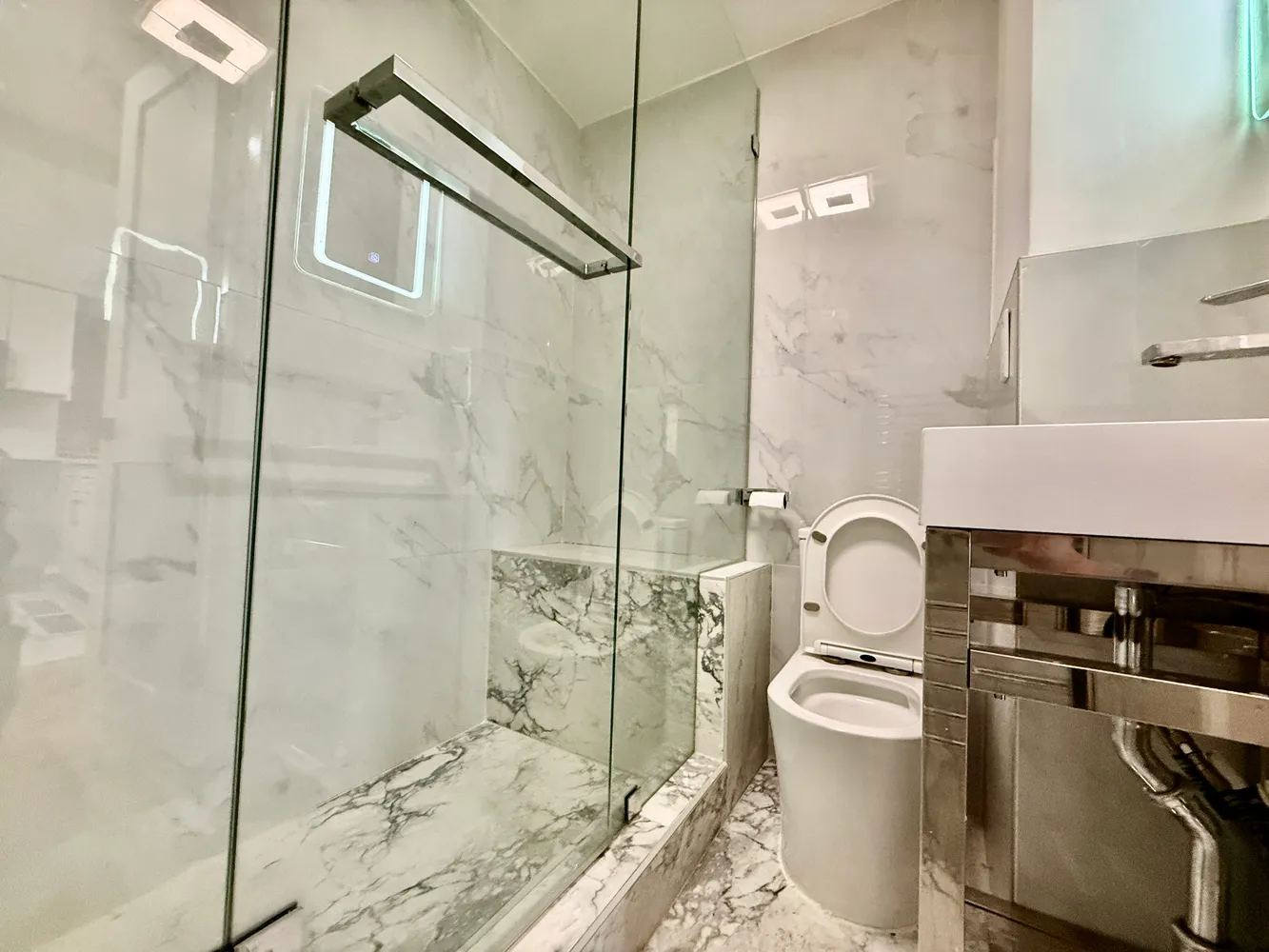a bathroom with a toilet and a shower