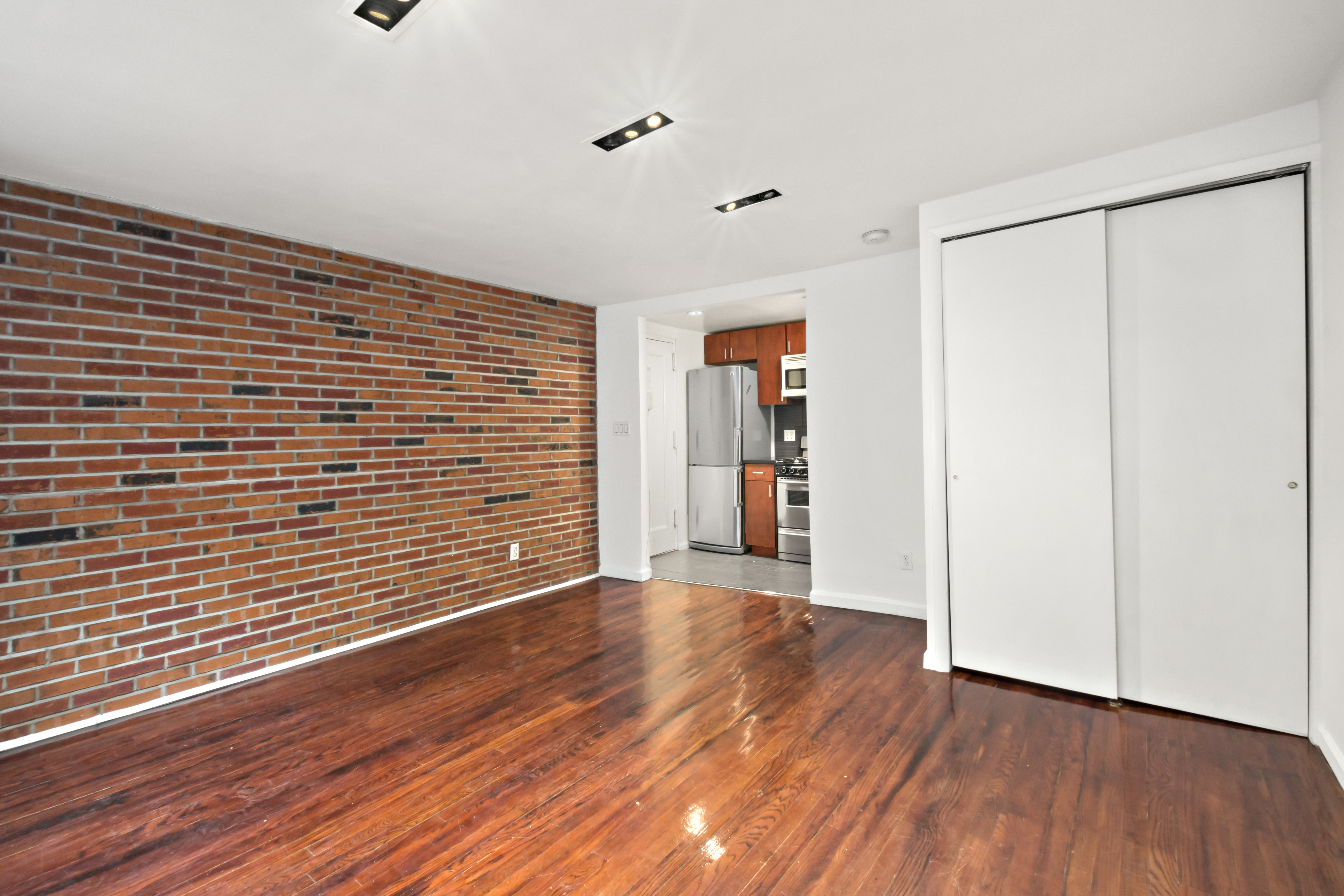 54 Jane Street Manhattan, NY 10014 - Photo 24 of 26 a view of an empty room with wooden floor and a window