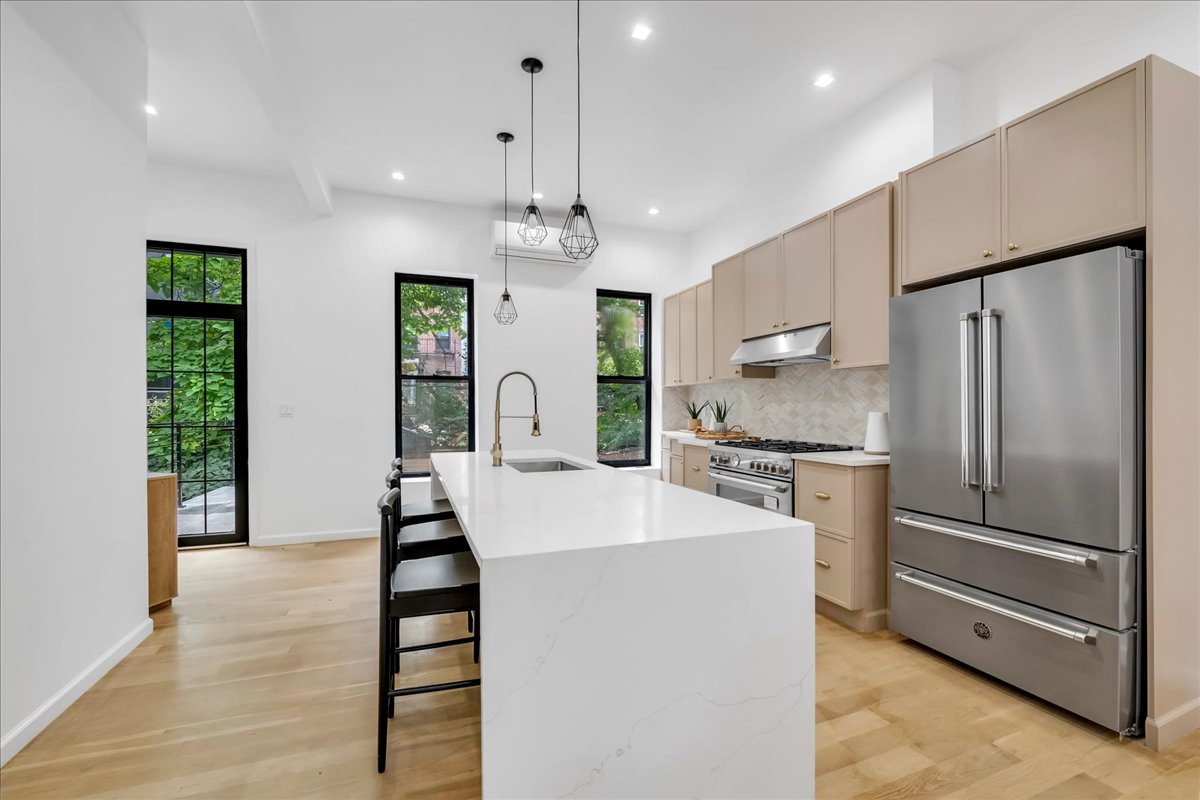 448 Halsey Street, Unit 1 Brooklyn, NY 11233 - Photo 8 of 22 a kitchen with stainless steel appliances a refrigerator and a stove top oven