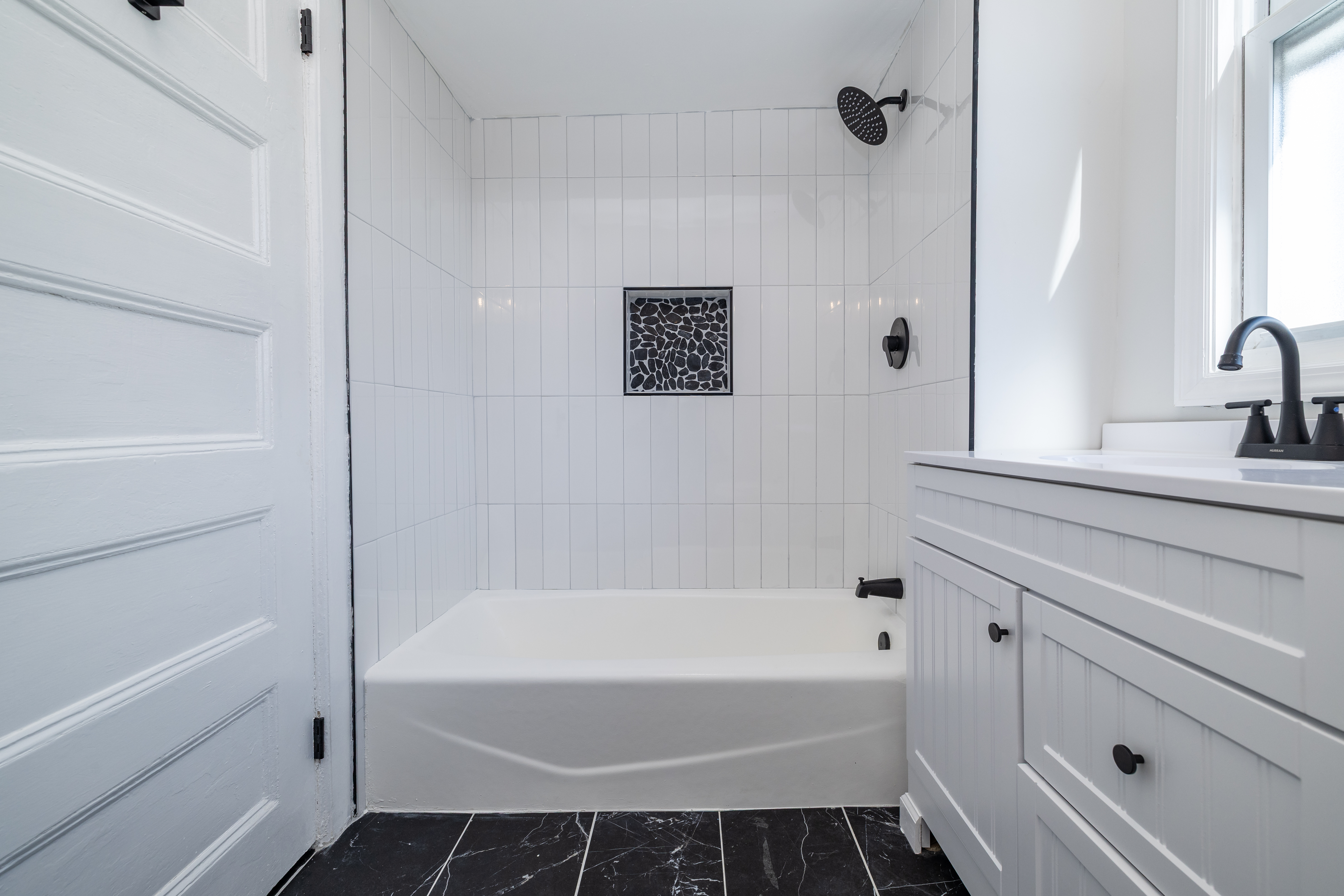 13-03 Brunswick Avenue Queens, NY 11691 - Photo 8 of 27 a bathroom with a bathtub and shower