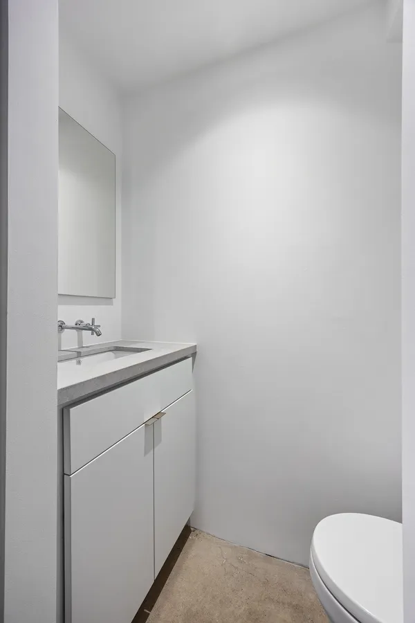 a bathroom with a sink a toilet and vanity