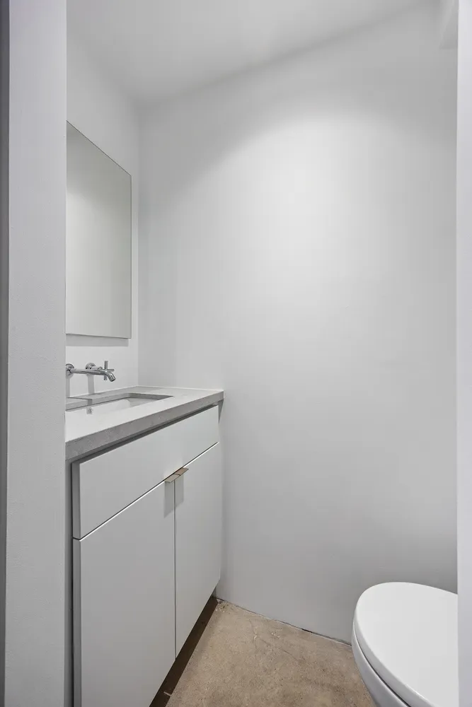 a bathroom with a sink a toilet and vanity