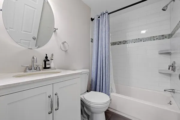 a bathroom with a sink toilet and shower