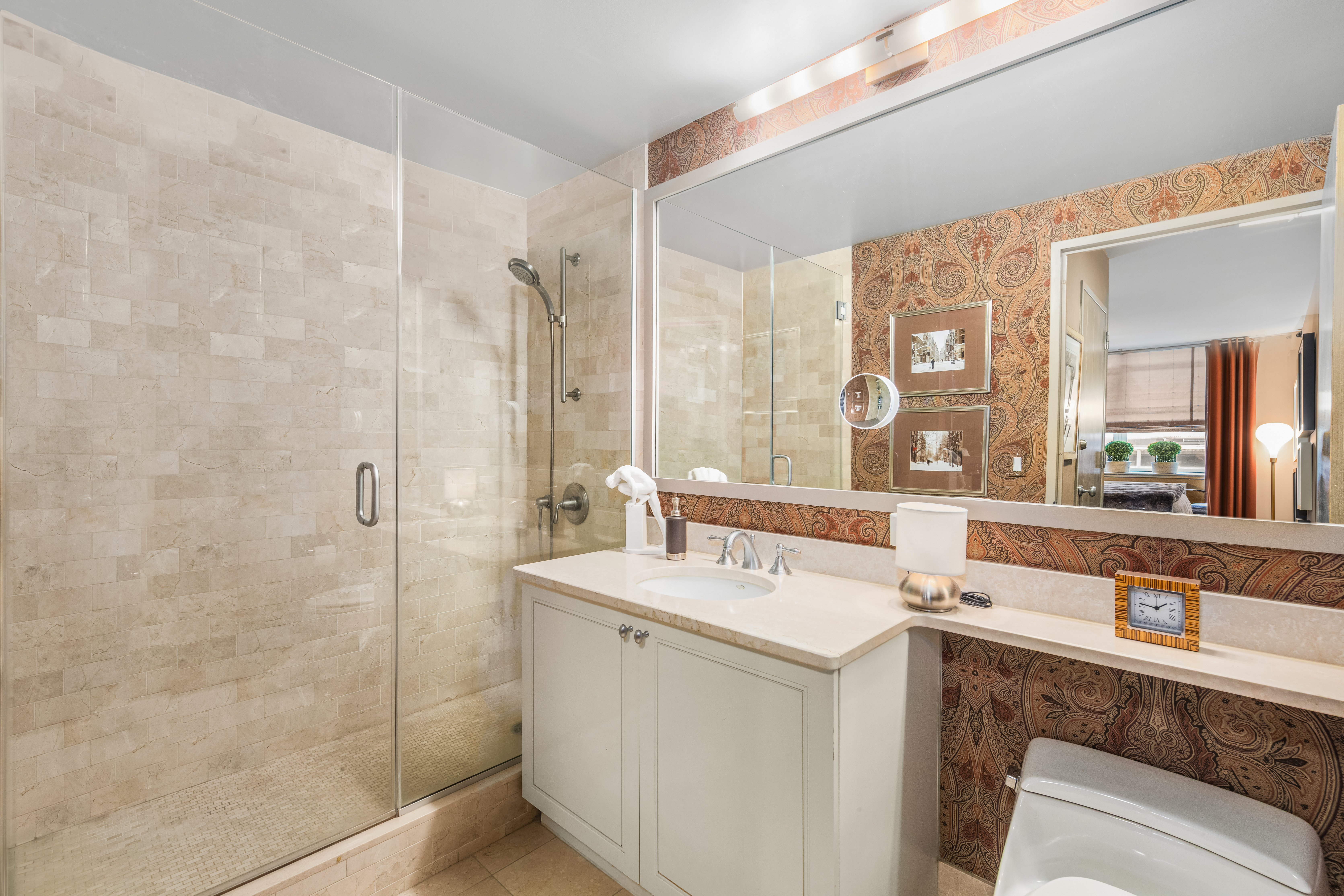 1760 2nd Avenue, Unit 2B Manhattan, NY 10128 - Photo 7 of 13 a room with a sink a mirror and a shower