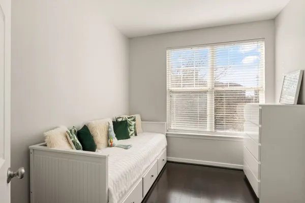 a bedroom with a bed and window