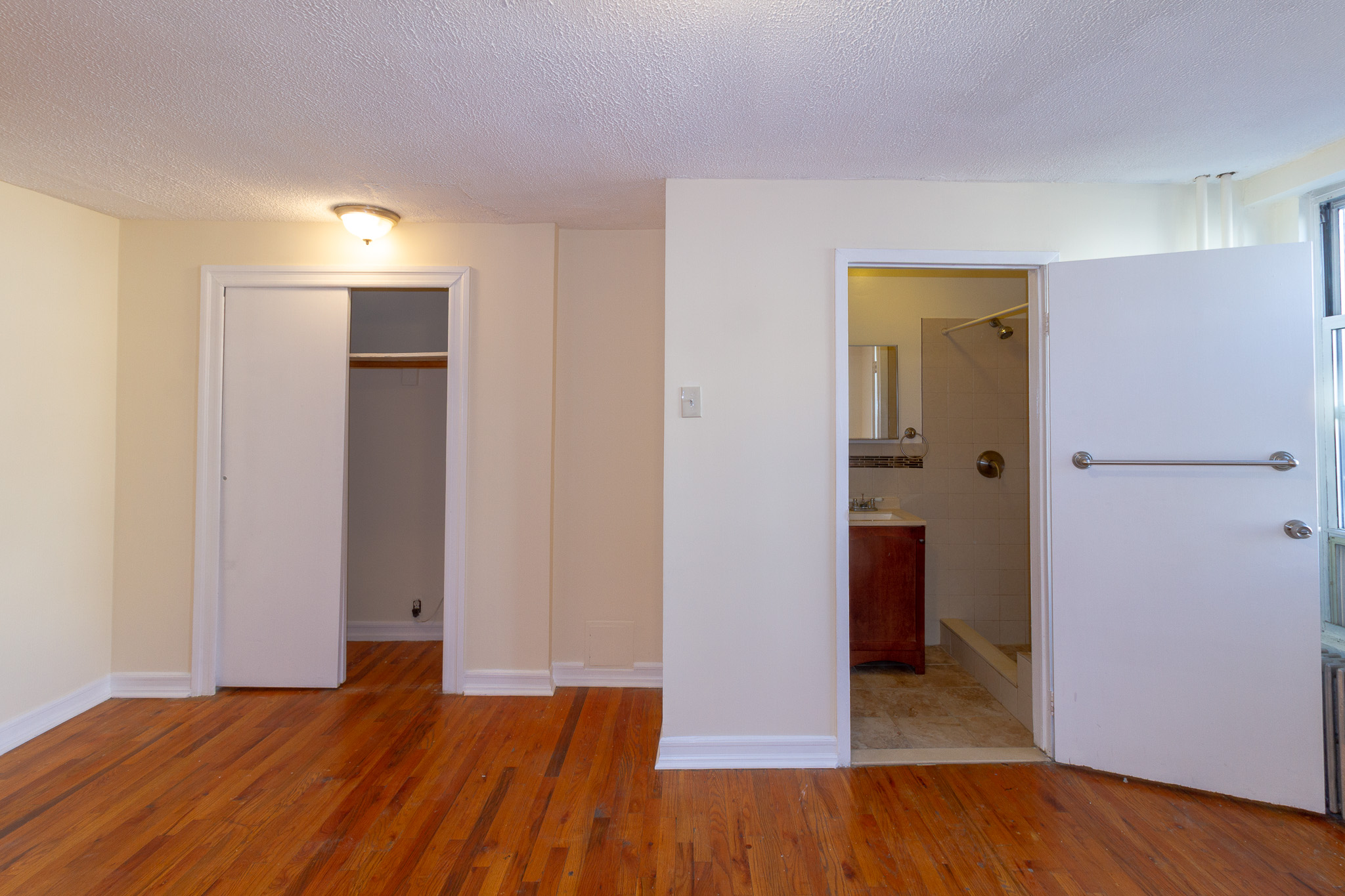 145 Atlantic Avenue, Unit 2 Brooklyn, NY 11201 - Photo 10 of 11 a view of a room with wooden floor and a bathroom