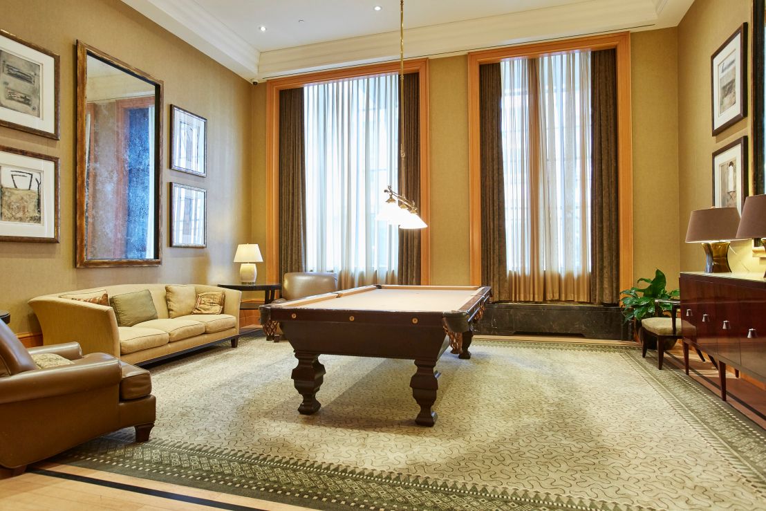 a living room with furniture and large windows