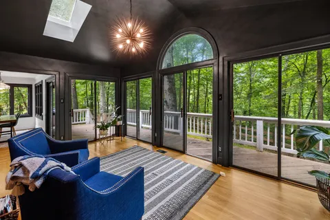 a living room with furniture and large windows