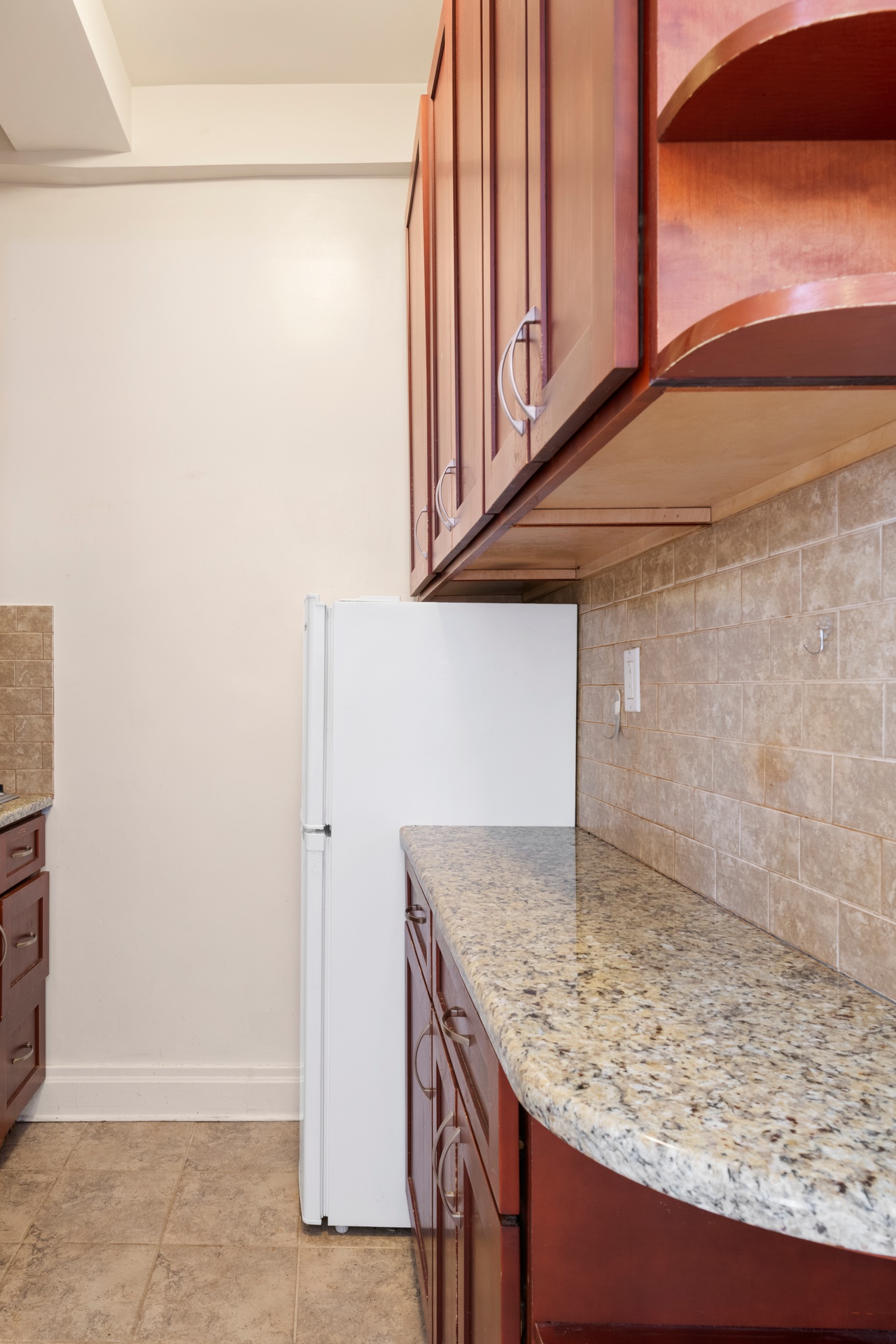 20 West 72nd Street, Unit 1106B Manhattan, NY 10023 - Photo 7 of 10 a kitchen with a sink and a refrigerator