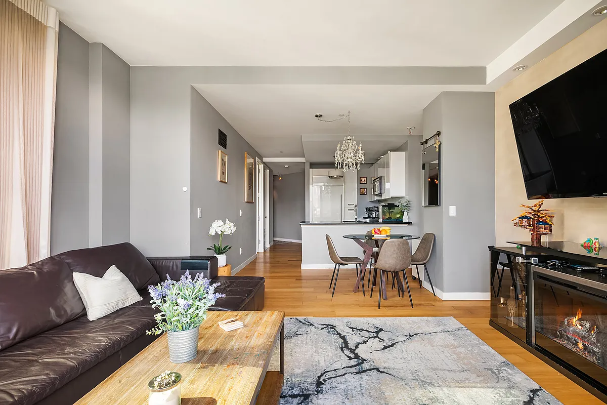 46-30 Center Boulevard, Unit 710 Queens, NY 11109 - Photo 2 of 25 a living room with furniture and a flat screen tv