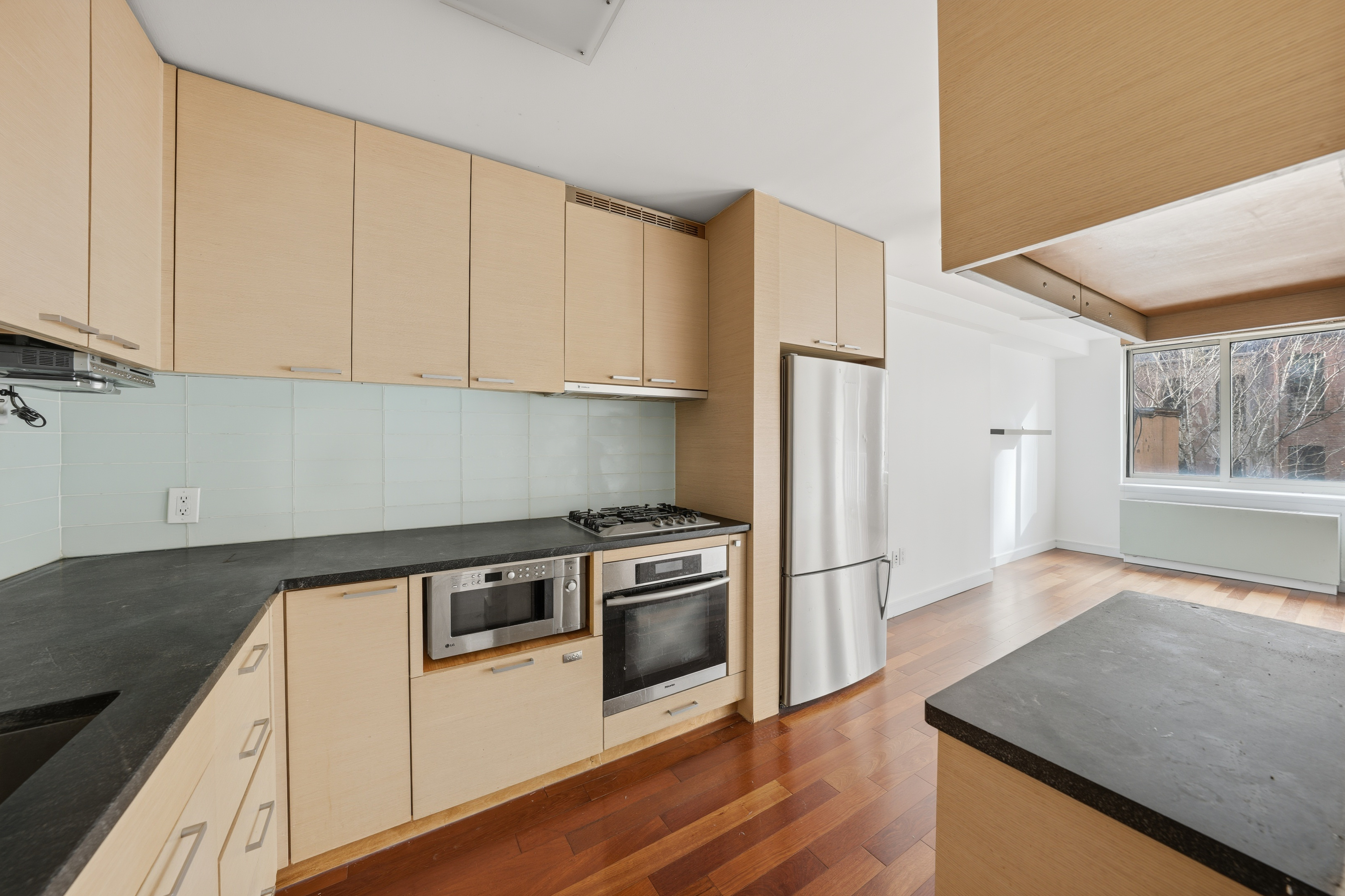 206 East 95th Street, Unit 6B Manhattan, NY 10128 - Photo 16 of 25 a kitchen with a stove a refrigerator and a sink