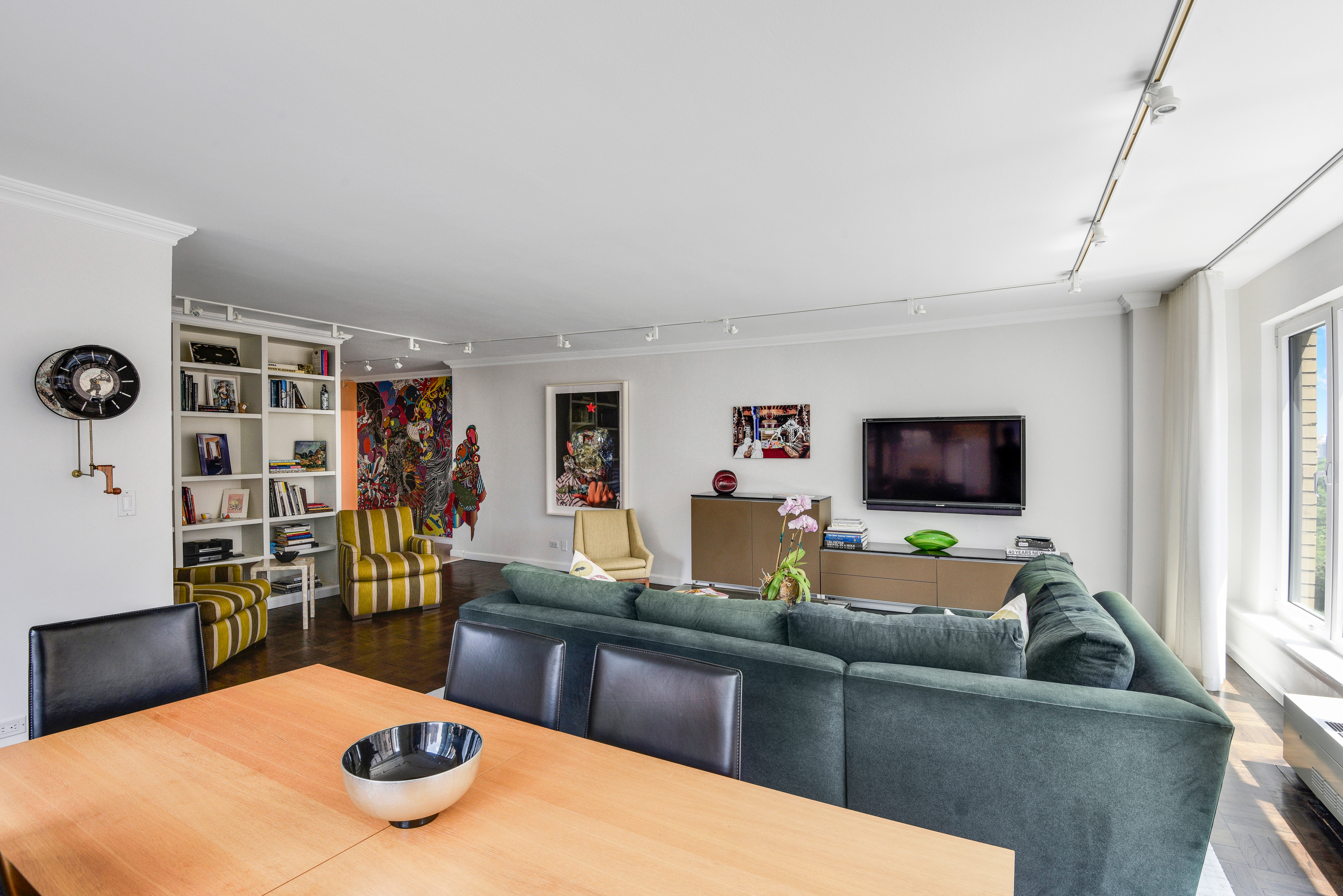 200 Central Park South, Unit 19J Manhattan, NY 10019 - Photo 6 of 12 a living room with furniture and a flat screen tv