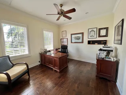 a living room with fireplace furniture and a wooden floor