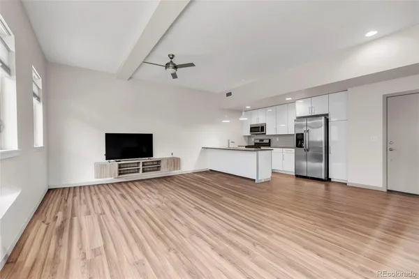 a kitchen with kitchen island a counter top space stainless steel appliances and cabinets