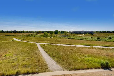 a view of a city with tall buildings and a big yard
