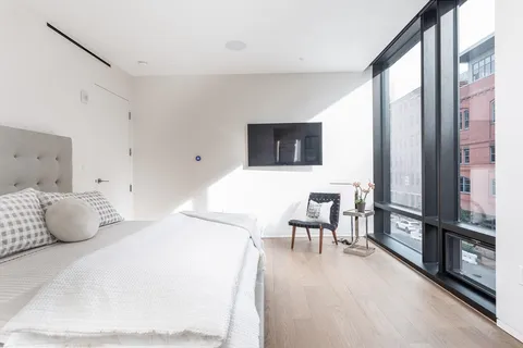 a large white bed in a small room