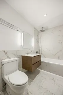 a bathroom with a toilet a sink and bathtub
