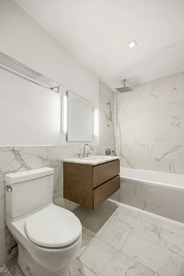 a bathroom with a toilet a sink and bathtub
