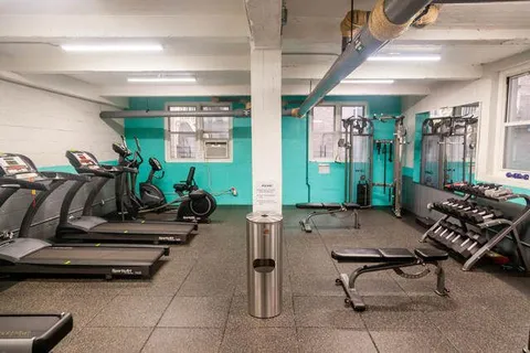 a room with gym equipment and a large window