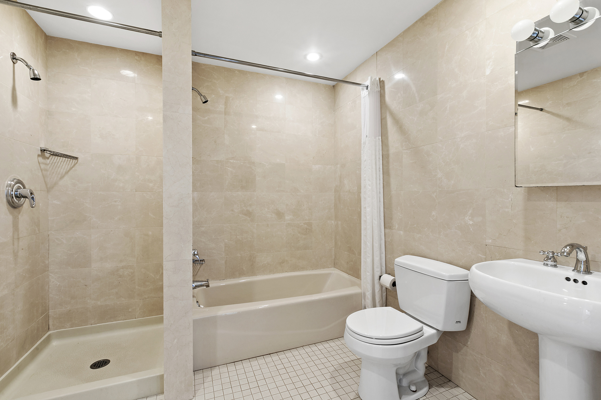 85 Division Street, Unit 4 Manhattan, NY 10002 - Photo 7 of 22 a bathroom with a sink toilet and shower