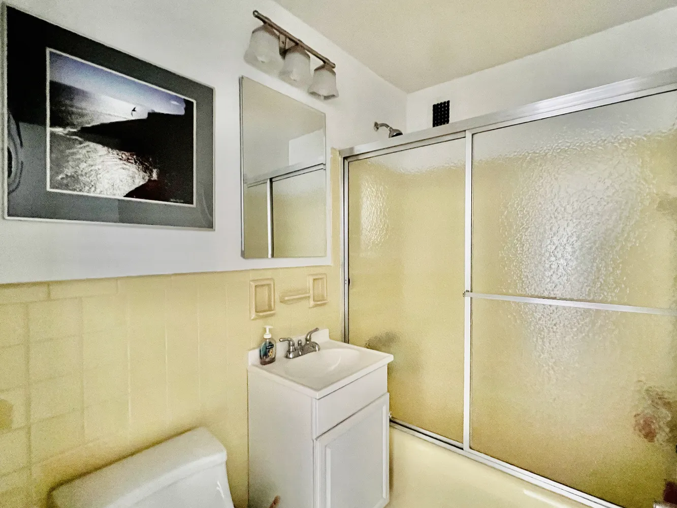 a bathroom with a shower and a sink