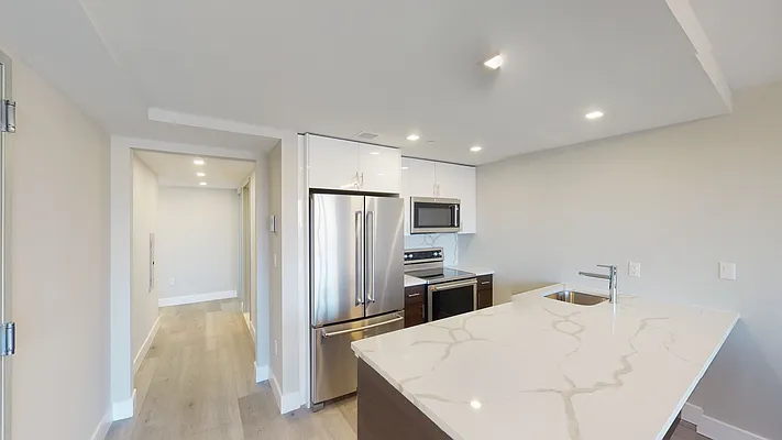a kitchen with stainless steel appliances a refrigerator and a stove