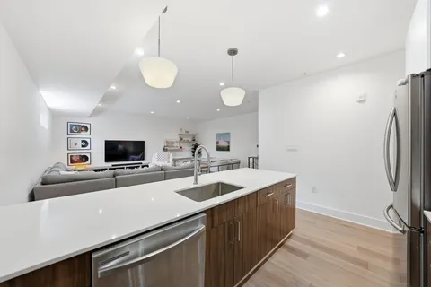 a kitchen with stainless steel appliances a sink and a refrigerator