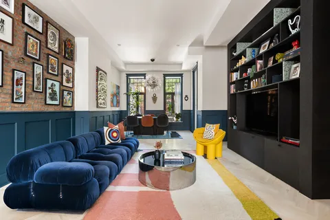 a living room with furniture a rug and a window