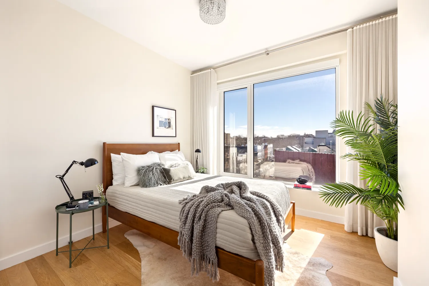 a bedroom with a bed and a potted plant