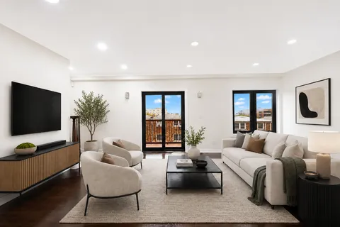 a living room with furniture a rug and kitchen view