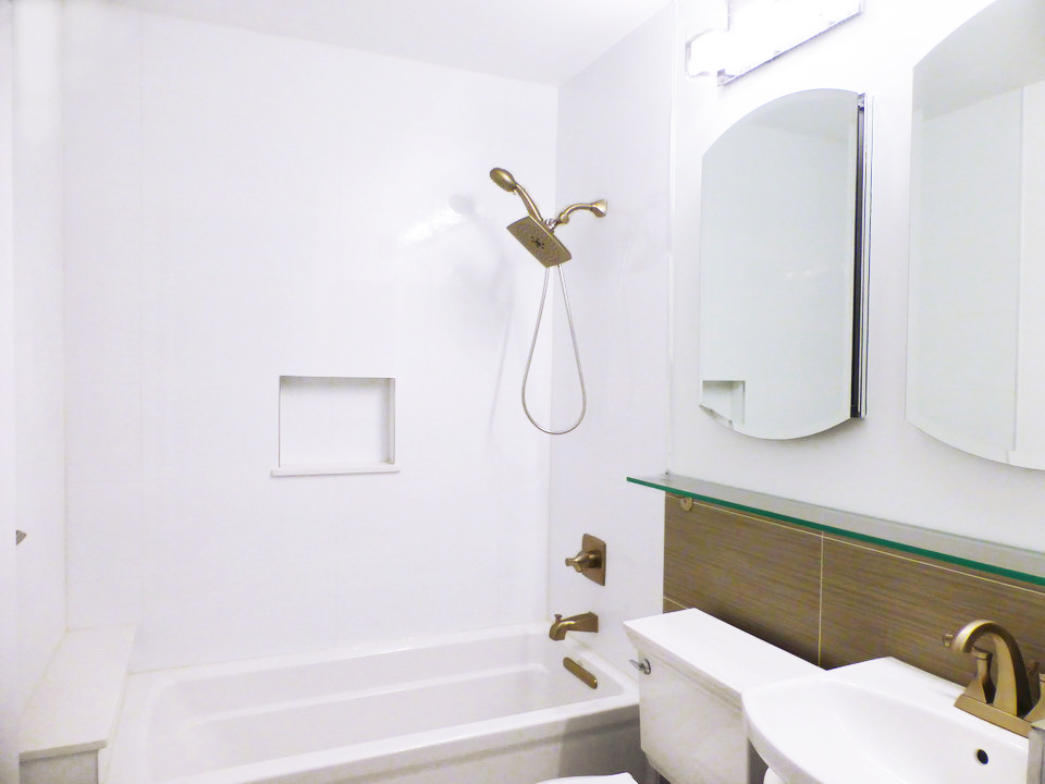 300 East 62nd Street, Unit 1405 Manhattan, NY 10065 - Photo 8 of 10 a bathroom with a shower and a bathtub