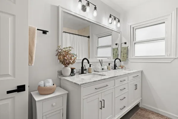 a bathroom with a granite countertop sink mirror and vanity