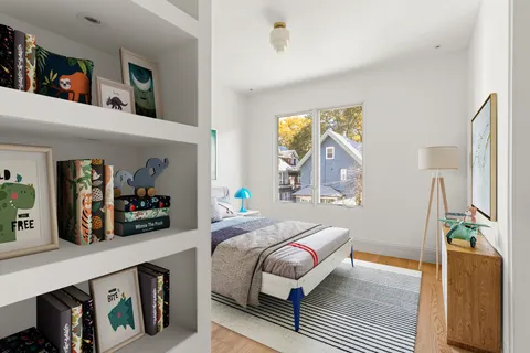 a bedroom with a bed a mirror and book shelf