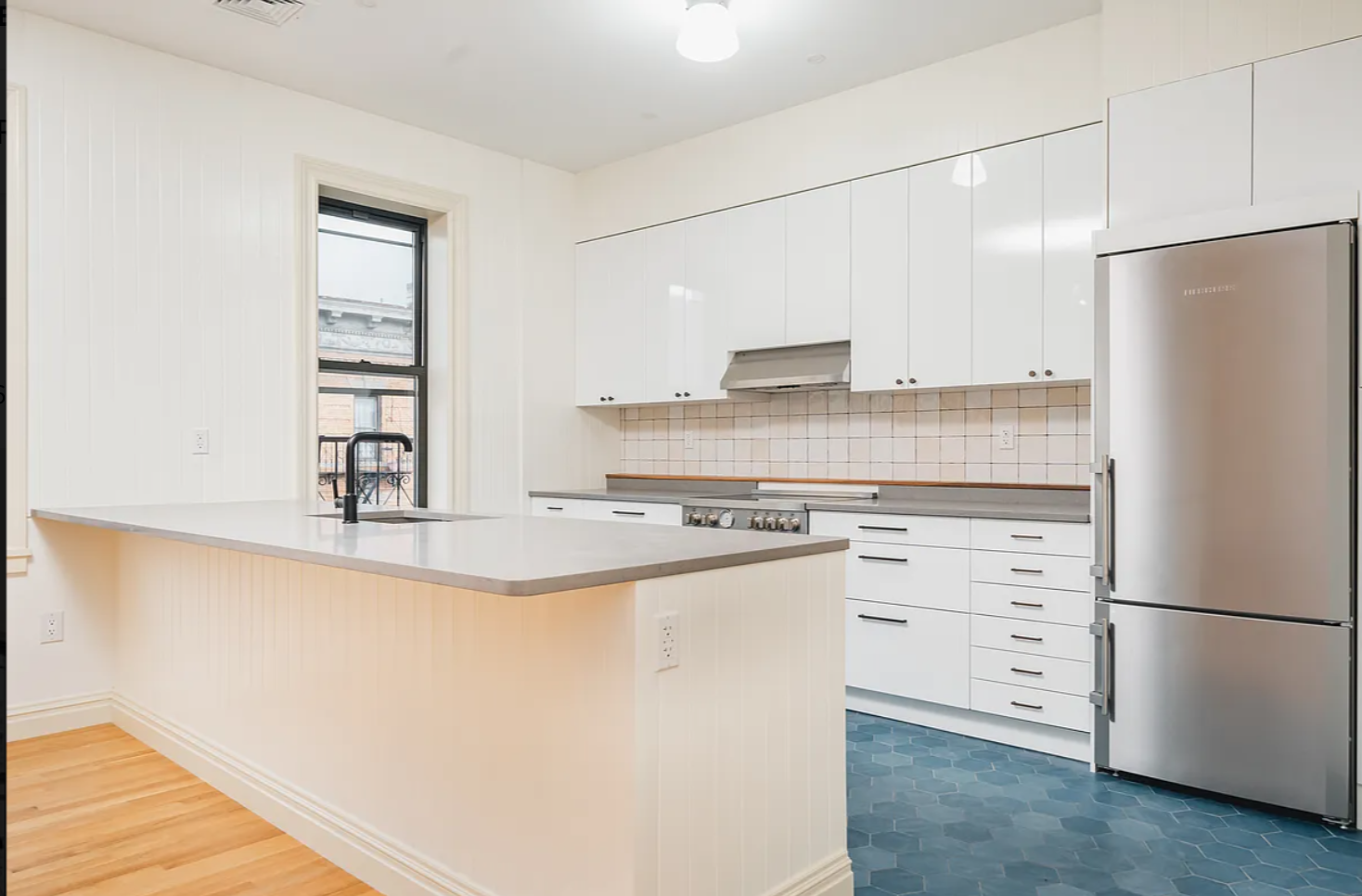 68-38 Forest Avenue, Unit 3R Queens, NY 11385 - Photo 5 of 15 a kitchen with stainless steel appliances white cabinets and a refrigerator