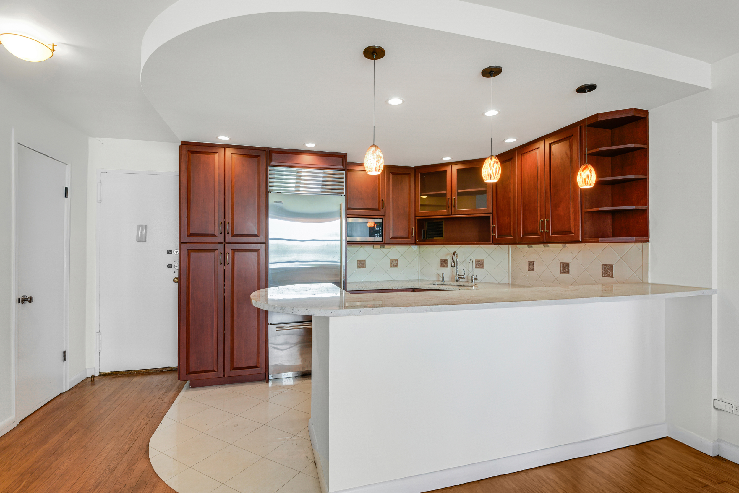 88 Bleecker Street, Unit 5J Manhattan, NY 10012 - Photo 6 of 18 a kitchen with stainless steel appliances a refrigerator and a sink