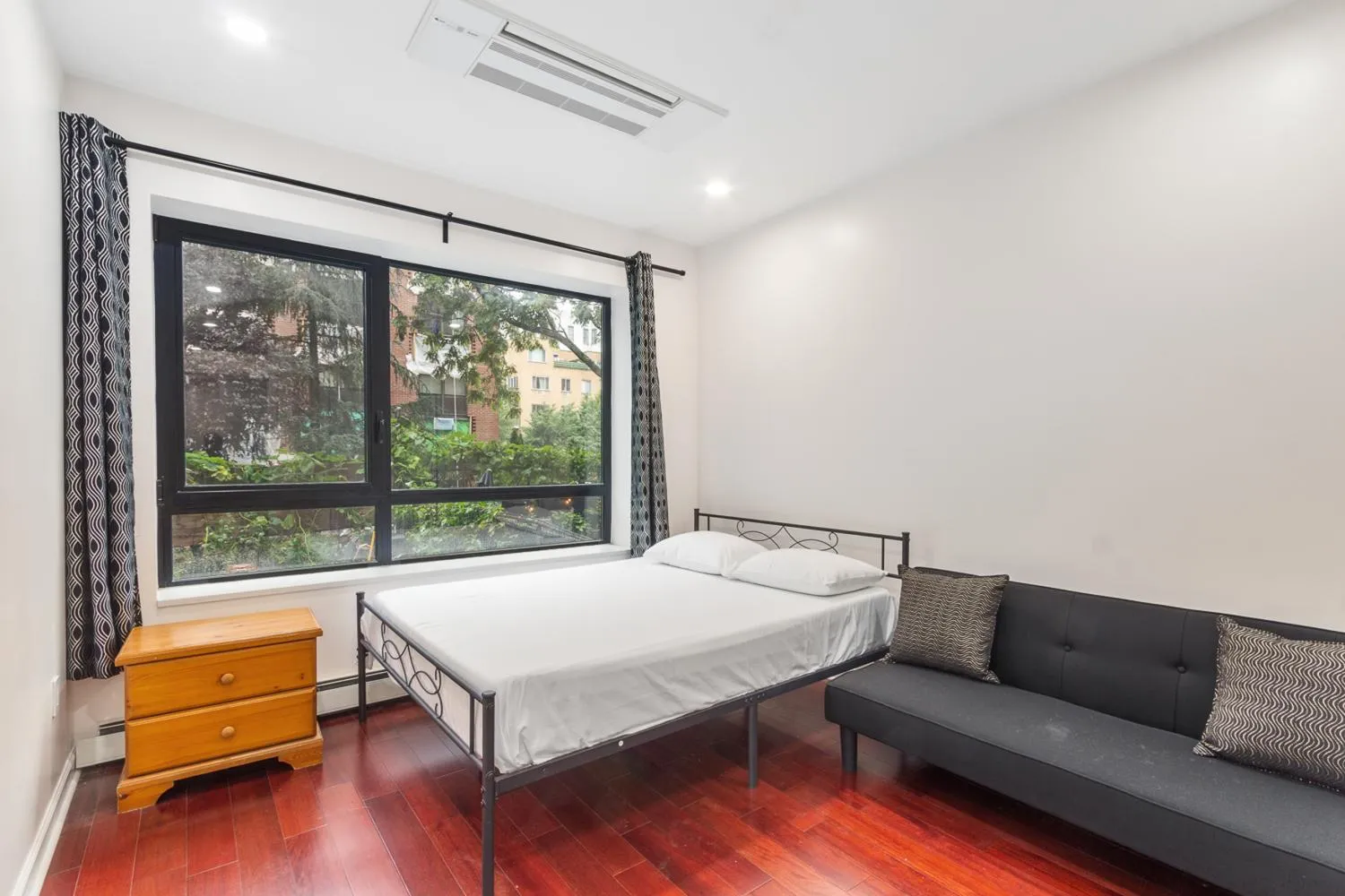 a bedroom with a bed and a couch