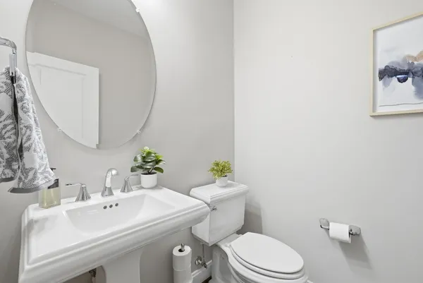 a bathroom with a sink mirror and toilet