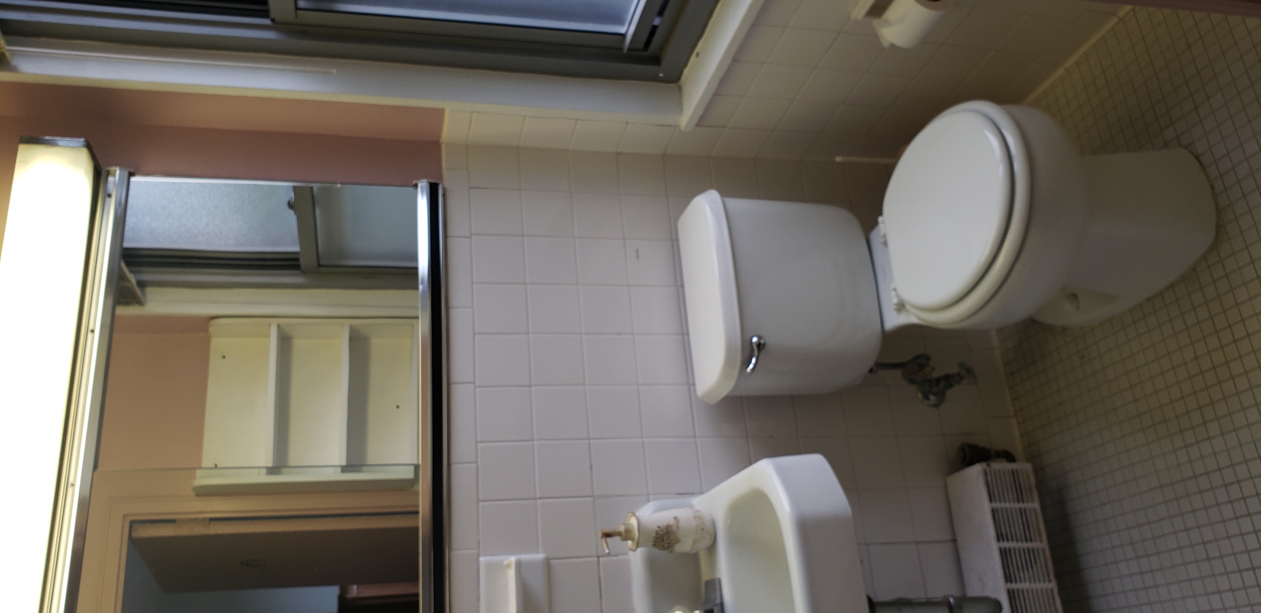 70-25 Yellowstone Boulevard, Unit 2M Queens, NY 11375 - Photo 15 of 23 a white toilet sitting next to a bathroom sink