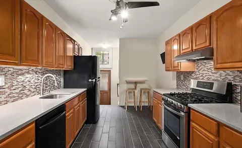 a kitchen with stainless steel appliances a stove sink microwave and cabinets