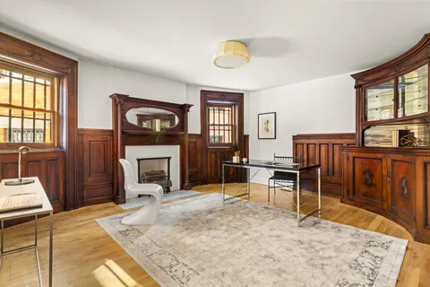 a living room with furniture a fireplace and a table