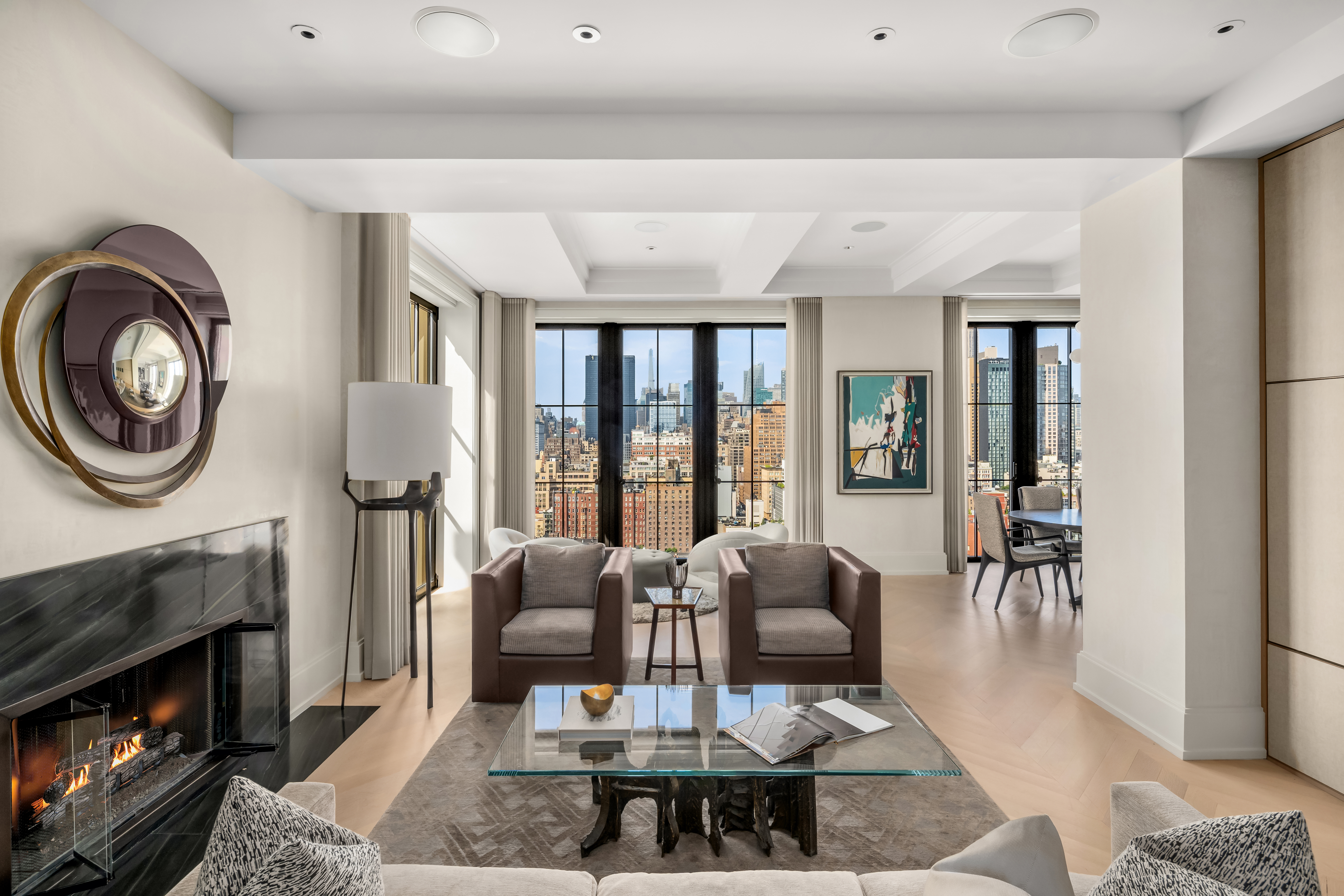 212 West 18th Street, Unit 19C Manhattan, NY 10011 - Photo 3 of 27 a living room with furniture a flat screen tv and a fireplace