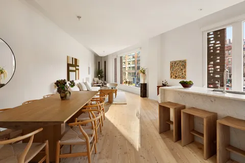 a view of a dining room with furniture and chandelier