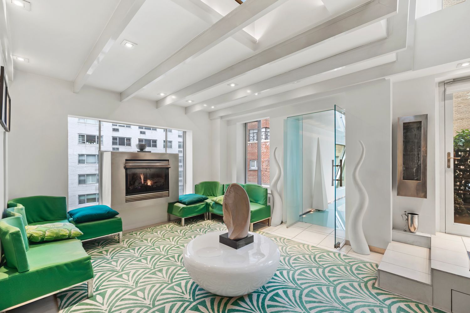 a living room with furniture a fireplace and a potted plant