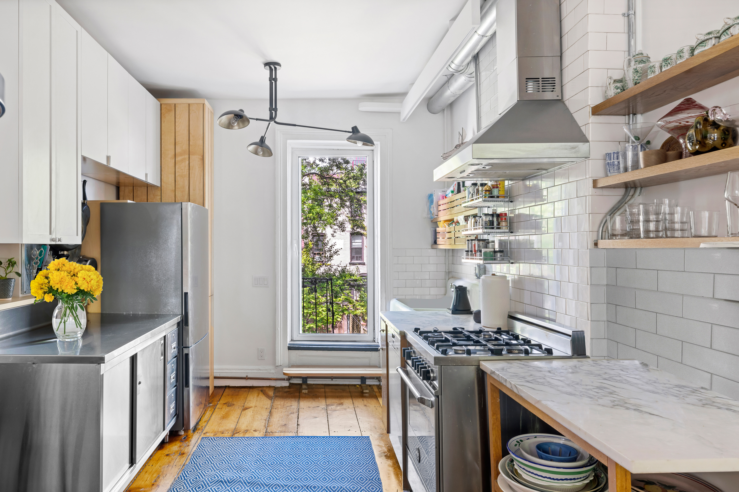 437 Warren Street Brooklyn, NY 11217 - Photo 6 of 17 a kitchen with granite countertop a stove and a refrigerator