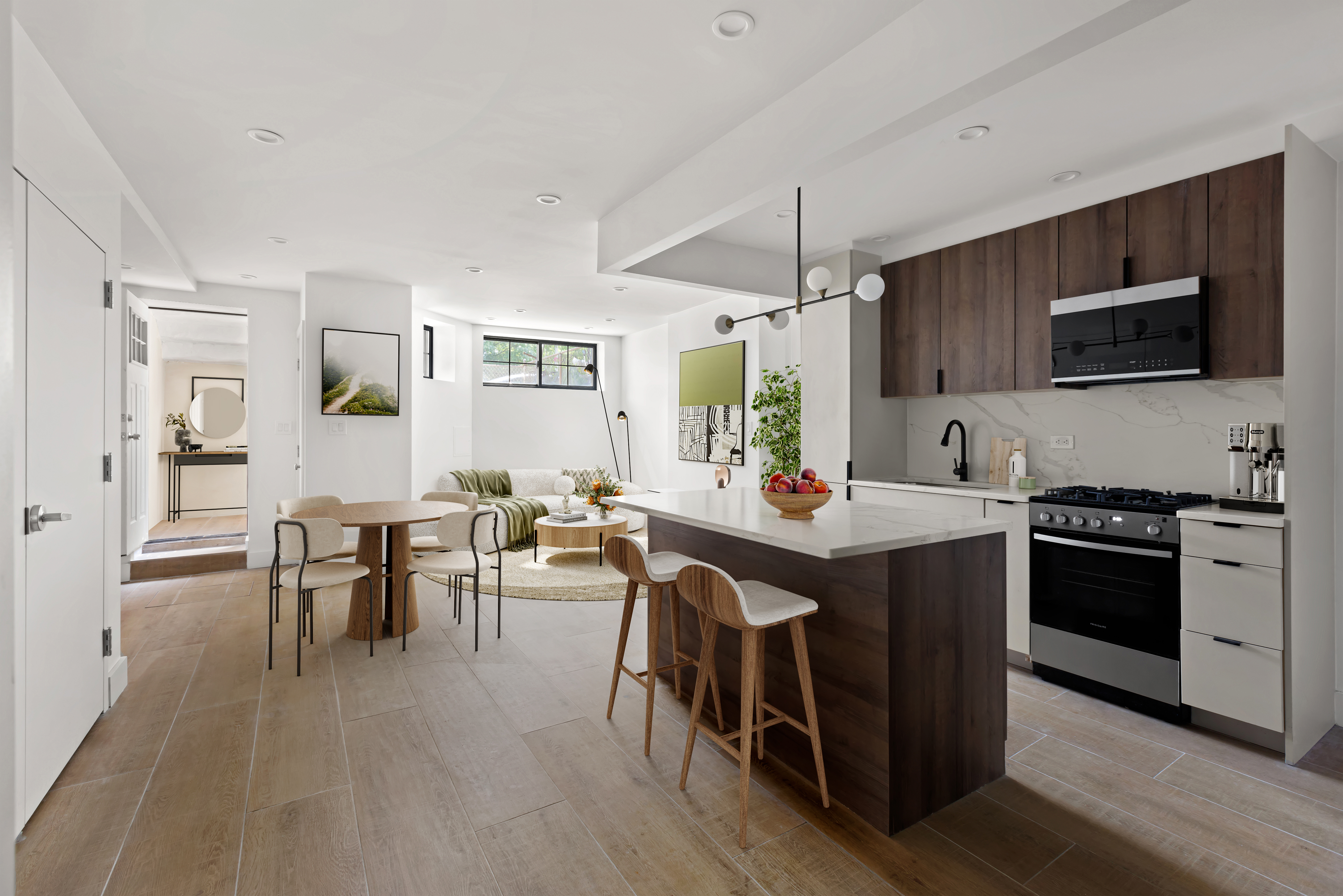 45-08 11th Street, Unit GARDEN Queens, NY 11101 - Photo 2 of 9 a kitchen with stainless steel appliances granite countertop a stove a sink dishwasher a dining table and chairs with wooden floor