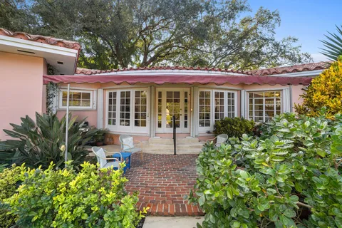 a front view of a house with a garden