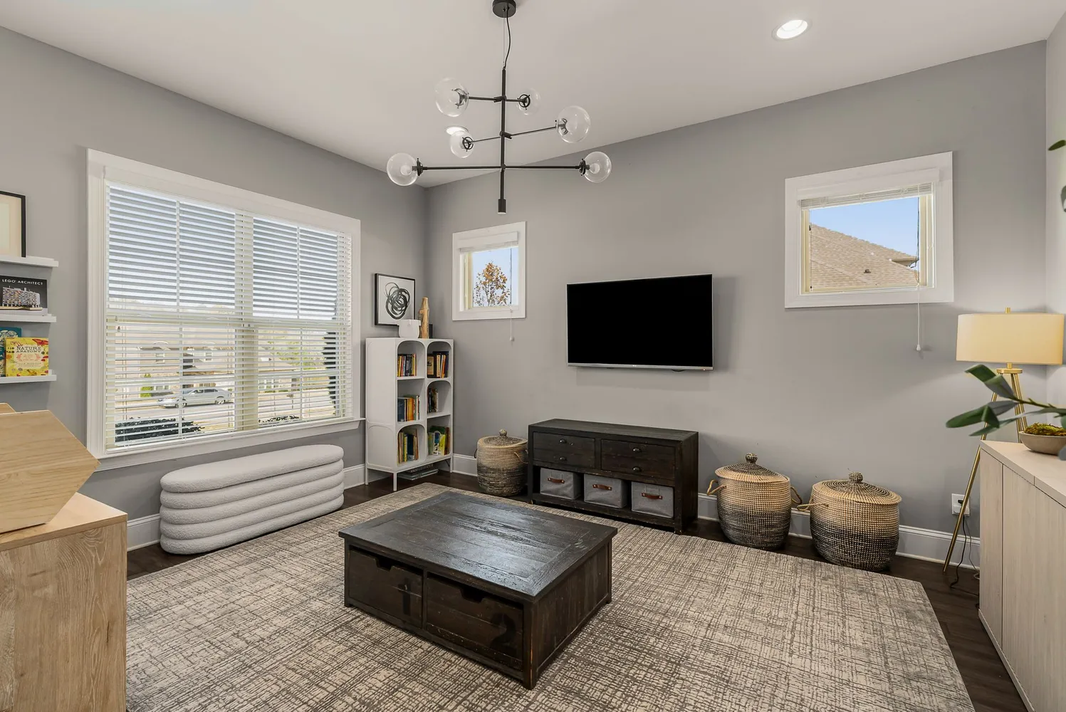 a living room with furniture and a dining table