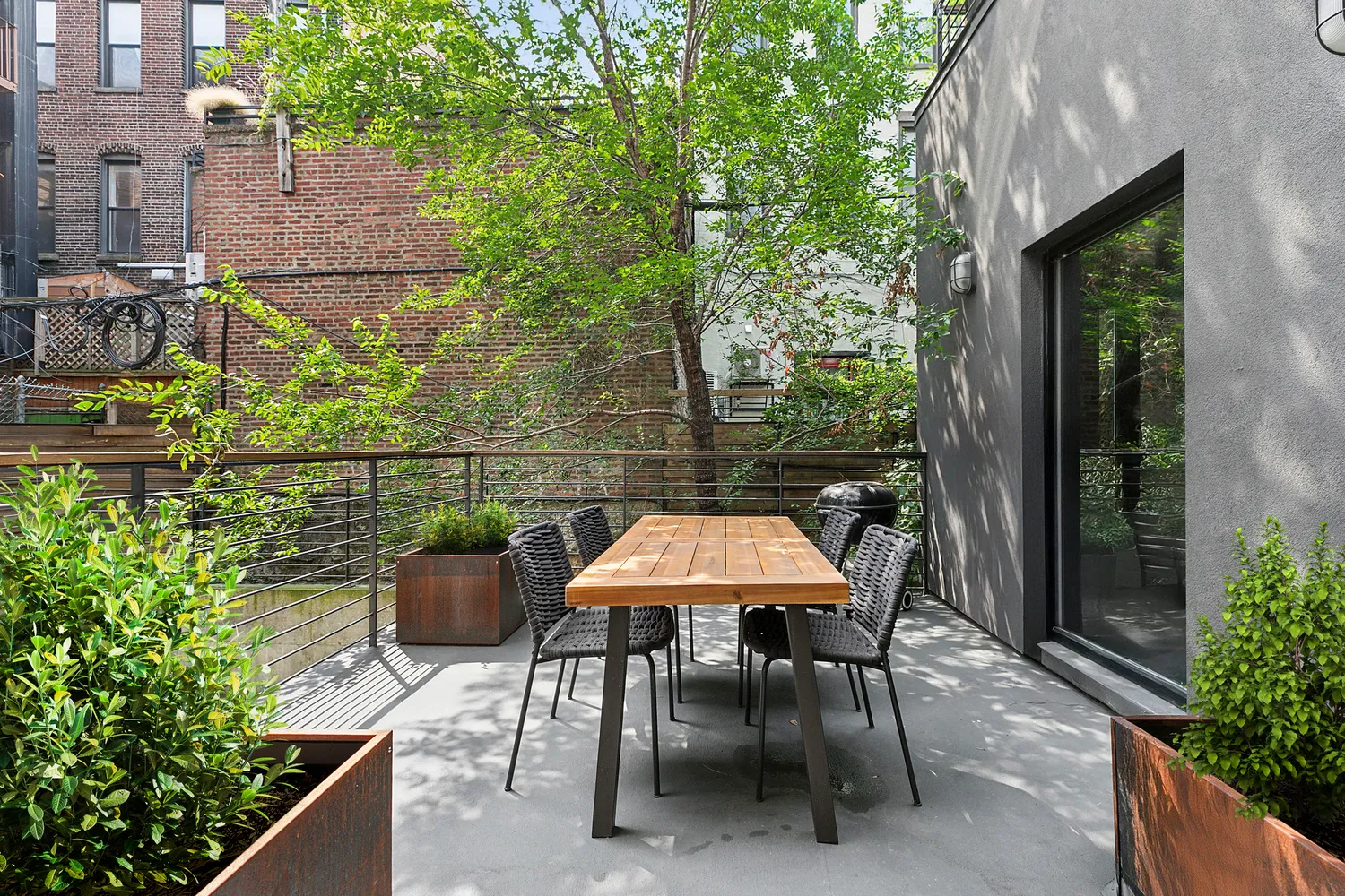 a view of a patio with table and chairs and potted plants