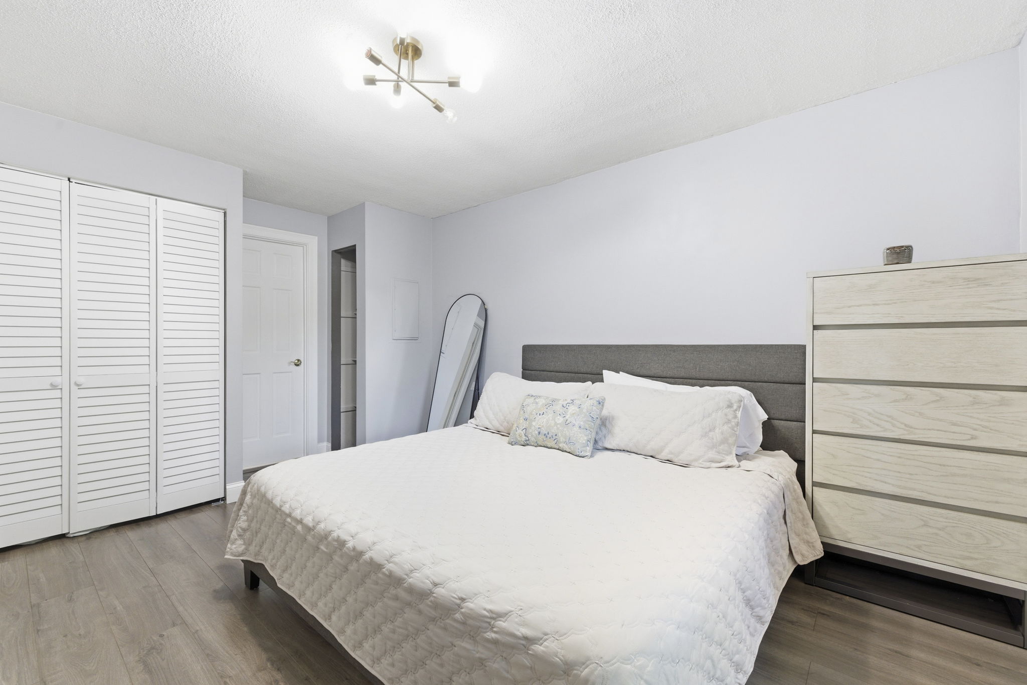 61 Wright Street, Unit 102 Stoneham, MA 02180 - Photo 16 of 26 a large bed sitting in a bedroom next to a window