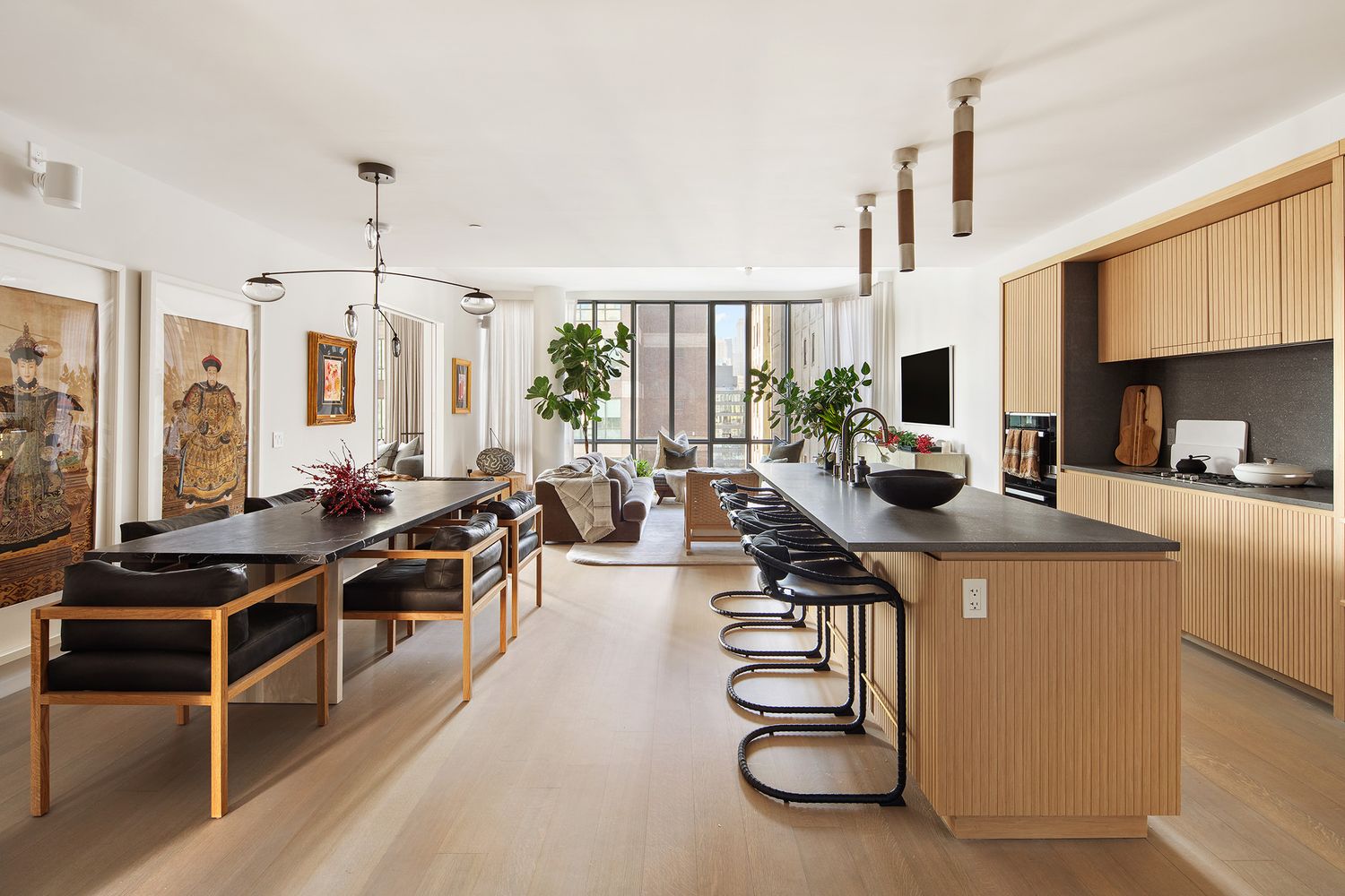 a kitchen with counter top space a stove and a view of living room